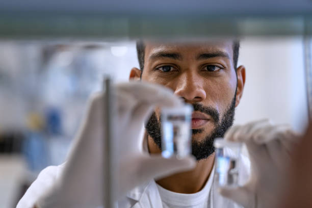 Researcher comparing Tirzepatide and Semaglutide peptide vials in a lab setting